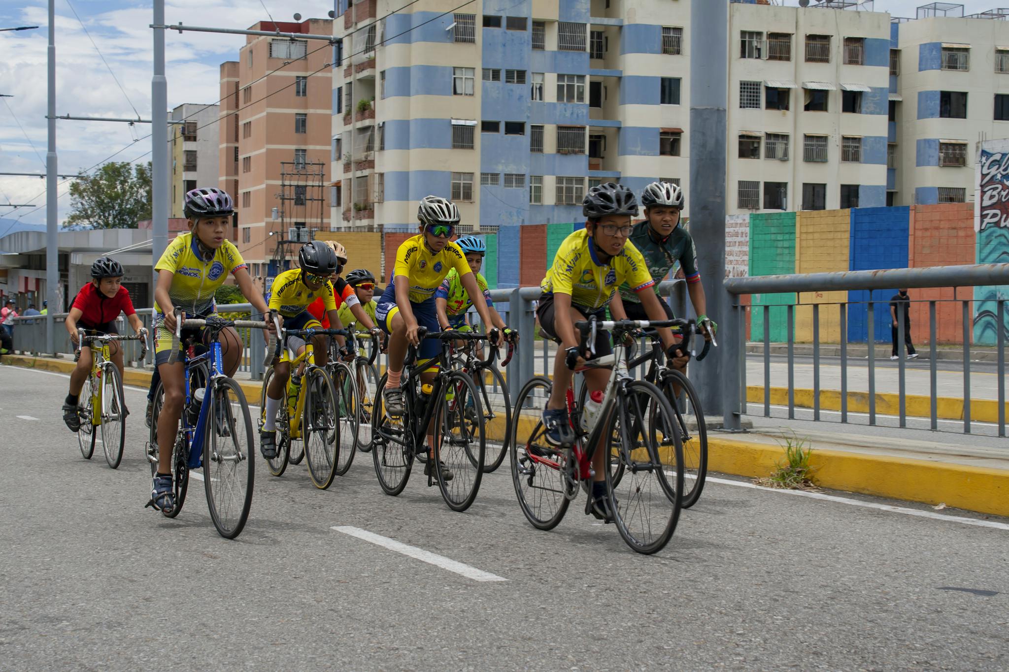 A group of young cyclists competing on a bike lane in Mérida, Venezuela. Perfect for sports themes.